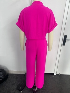 Rear view of vibrant pink short sleeve lapel shirt and straight leg trousers set
