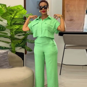 Detail of light green two-piece set featuring texture crop shirt and high waist wide leg pants