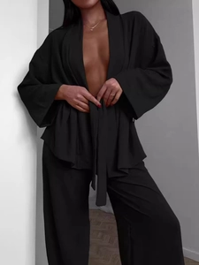 Women's black lounge set with wrap tie top and wide leg pants in soft cotton fabric
