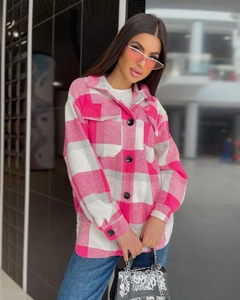 Detail of pink plaid flannel shirt featuring a classic collar and flap chest pockets