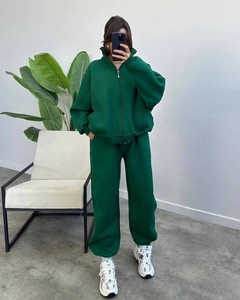 Detailed macro view of deep green oversized tracksuit featuring a stand collar and joggers