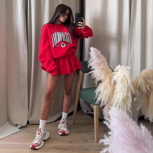 Detail view of red oversized California print sweatshirt and matching pleated mini skirt