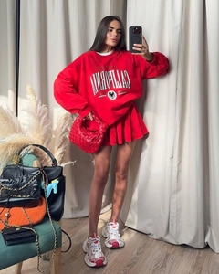 Detailed view of red California printed sweatshirt and matching pleated mini skirt set