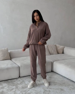 Détail d'un ensemble en polaire douce avec haut demi-zip et pantalon assorti