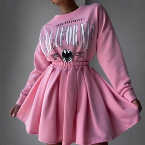 Close-up of pink fleece sweatshirt with California eagle print and pleated skirt