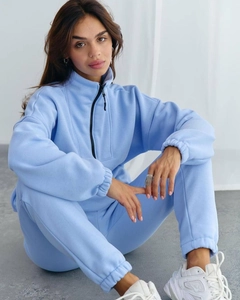 Detail of light blue fleece tracksuit set featuring a half-zip sweatshirt and joggers