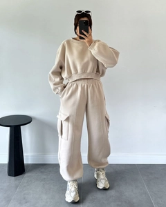Detail shot of apricot crewneck cropped sweatshirt and high-waist cargo jogger set