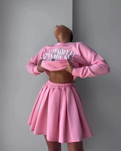 Close-up of pink California printed fleece sweatshirt and matching pleated mini skirt set