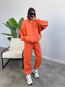 Women's orange fleece tracksuit with zip-up sweatshirt and joggers in a relaxed fit