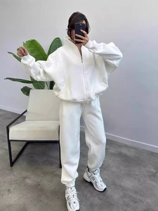 Women's minimalist white fleece tracksuit featuring full-zip hoodie and jogger pants