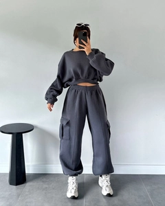 Detail of high-waisted charcoal cargo joggers with elastic waistband and side pockets
