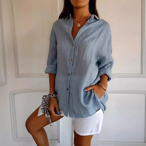 Women's light blue pleated button-down shirt with long roll-up sleeves and cotton texture