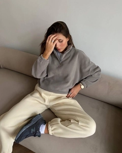 Detailed texture of gray fleece half-zip sweatshirt with premium embroidery