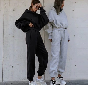 Close-up of baggy hooded sweatshirts and joggers set in black and light grey cotton fabric