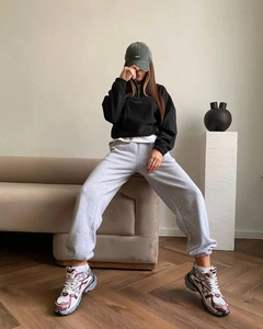 Detail of high collar half-zip hoodie with embroidered want text and street style outfit