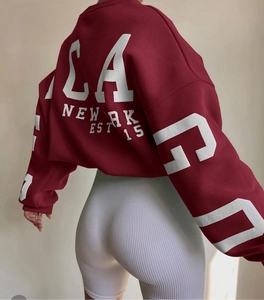 Detail view of burgundy oversized sweatshirt with retro white LA print on back and sleeves
