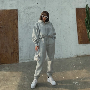 Detail of grey hooded sweatshirt and jogger set with drawstring and high waist