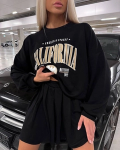 Close-up of black oversized sweatshirt featuring American vintage eagle print