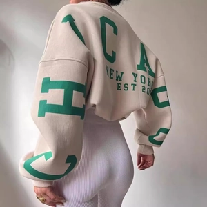 Women's oversized cream sweatshirt with green New York graphic print on the back