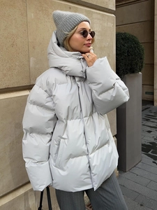 Side view of oversized quilted winter jacket with hood and windproof collar in light grey