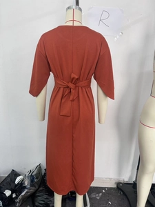 Detail view of the back tie-up waist design on a rust-colored modest midi dress