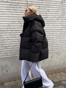 Detail view of black hooded puffer jacket with high collar and windproof matte finish