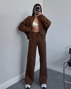 Detail view of brown zip-up hoodie and high-waisted wide-leg sweatpants set