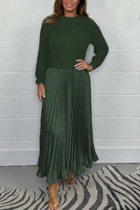 Detail of forest green knitted long sleeve top and pleated skirt with silk texture