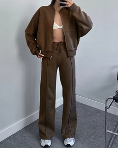 Detail of premium brown track jacket and wide-leg trousers set with zip-up collar style
