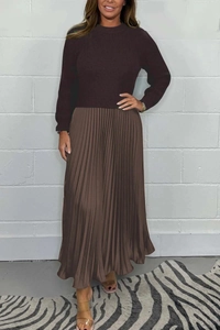 Detailed view of the dark brown knitted long sleeve top and pleated satin skirt combination