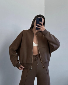 Detail of dark brown zip-up sweatshirt and matching drawstring sweatpants in soft fabric
