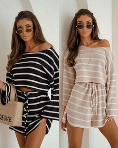 Detail of knitted striped two-piece set featuring off-shoulder top and drawstring shorts
