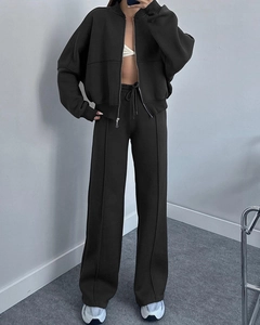Detail of black zipper jacket and high waist wide leg trousers with pleats