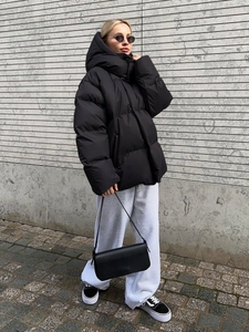 Oversized black hooded quilted jacket featuring street style aesthetic for autumn and winter