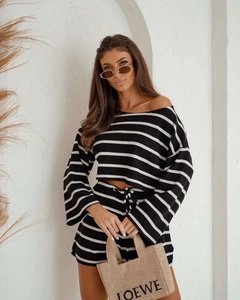 Close-up of waffle knit texture on off-shoulder black and white striped two-piece set