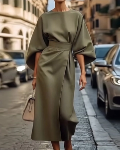 Detail of elegant olive green dress featuring high neckline and puff batwing sleeves