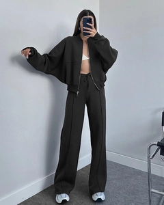 Detail of dark brown zip-up hoodie and wide-leg jogger set with drawstring waist
