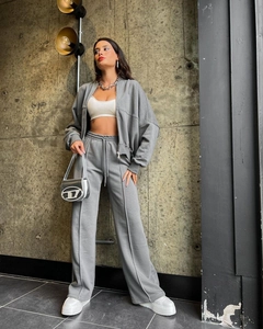 Detail of grey zip-up hoodie and high-waisted wide-leg trousers with vertical seams