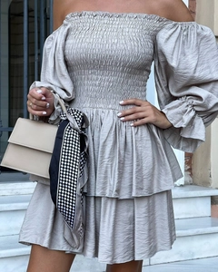 Detail of off-shoulder pleated mini dress with lantern sleeves and ruffled hem layers