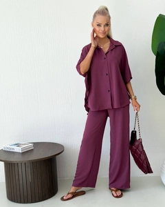 Detail of two-piece dark plum set with short sleeve lapel shirt and high-waist wide trousers