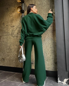 Detail view of dark green oversized zip-up hoodie set and high-waisted wide-leg trousers