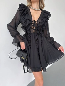 Detail of the elegant black chiffon V-neck dress with layered ruffle sleeves and waist ties