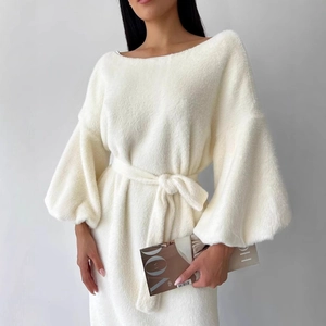 Close-up of elegant white long sleeve dress in soft fuzzy fabric with tie-waist detail