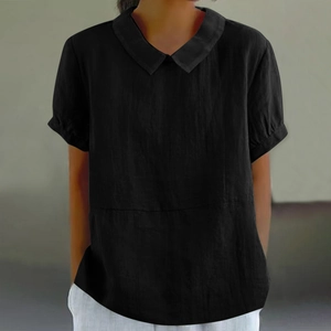 Detail of black loose-fit blouse with Peter Pan collar and textured cotton-linen fabric