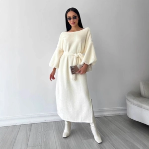 Detail of cream long-sleeved tie-waist dress with soft faux fur texture and side slit
