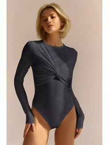 Detail of dark grey long sleeve bodysuit featuring front twist knot and ribbed texture