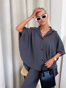 Women's dark gray two-piece lounge set with oversized lapel shirt and wide-leg pants