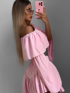 Detail of pink off-shoulder ruffled top with elastic neckline and elegant chiffon texture