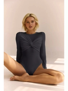 Detail of long sleeve bodysuit featuring a twisted knot and pleated chest design