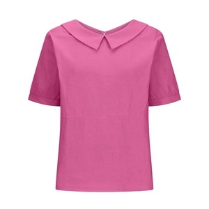 Detail of pink short-sleeve shirt featuring a Peter Pan collar and soft textured fabric